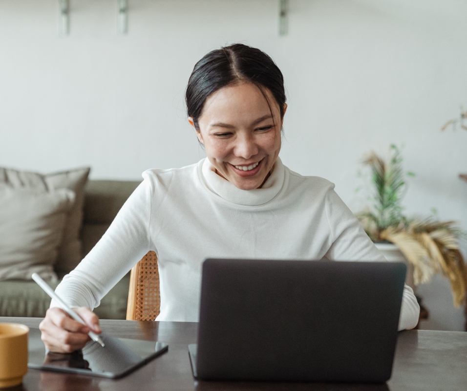 Woman smiling looking at her laptop